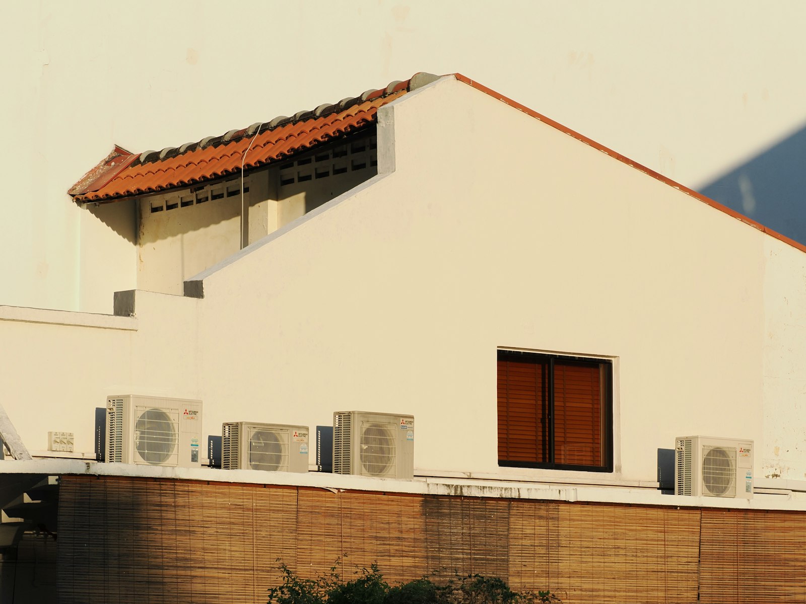 Outdoor air-conditioning condensers on a building terrace.
